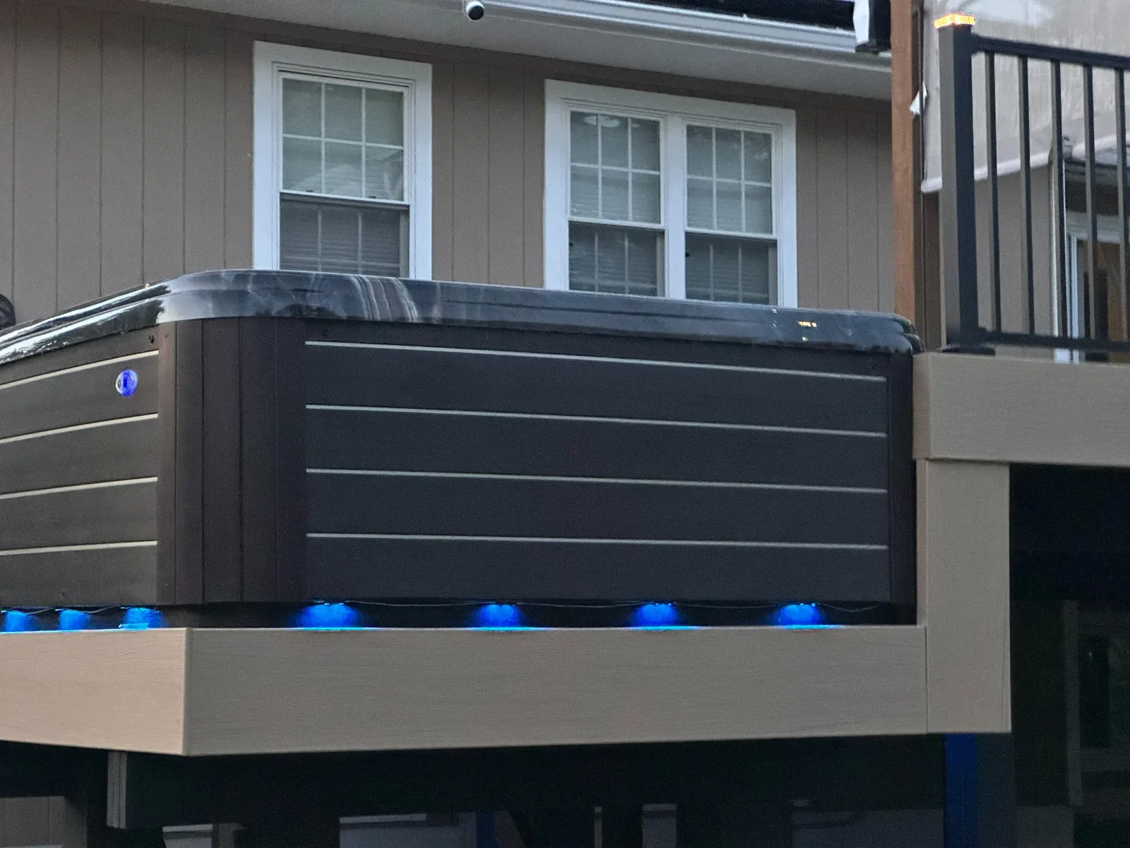 Elevated Trex spa deck with a stone base