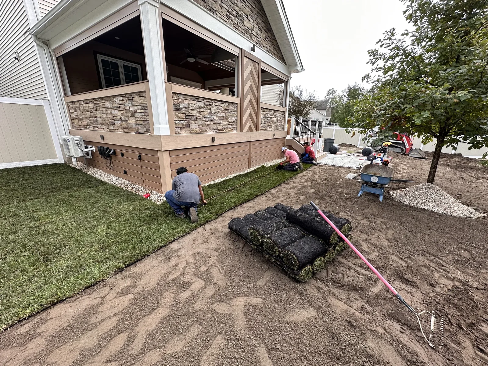 Paver patio with a fire pit beside the deck in the Hudson Valley