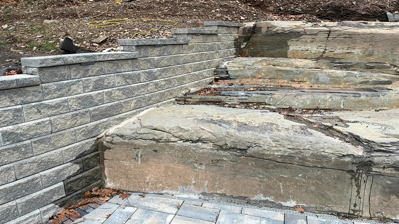 Natural ledge, retaining wall, and paver transition detail