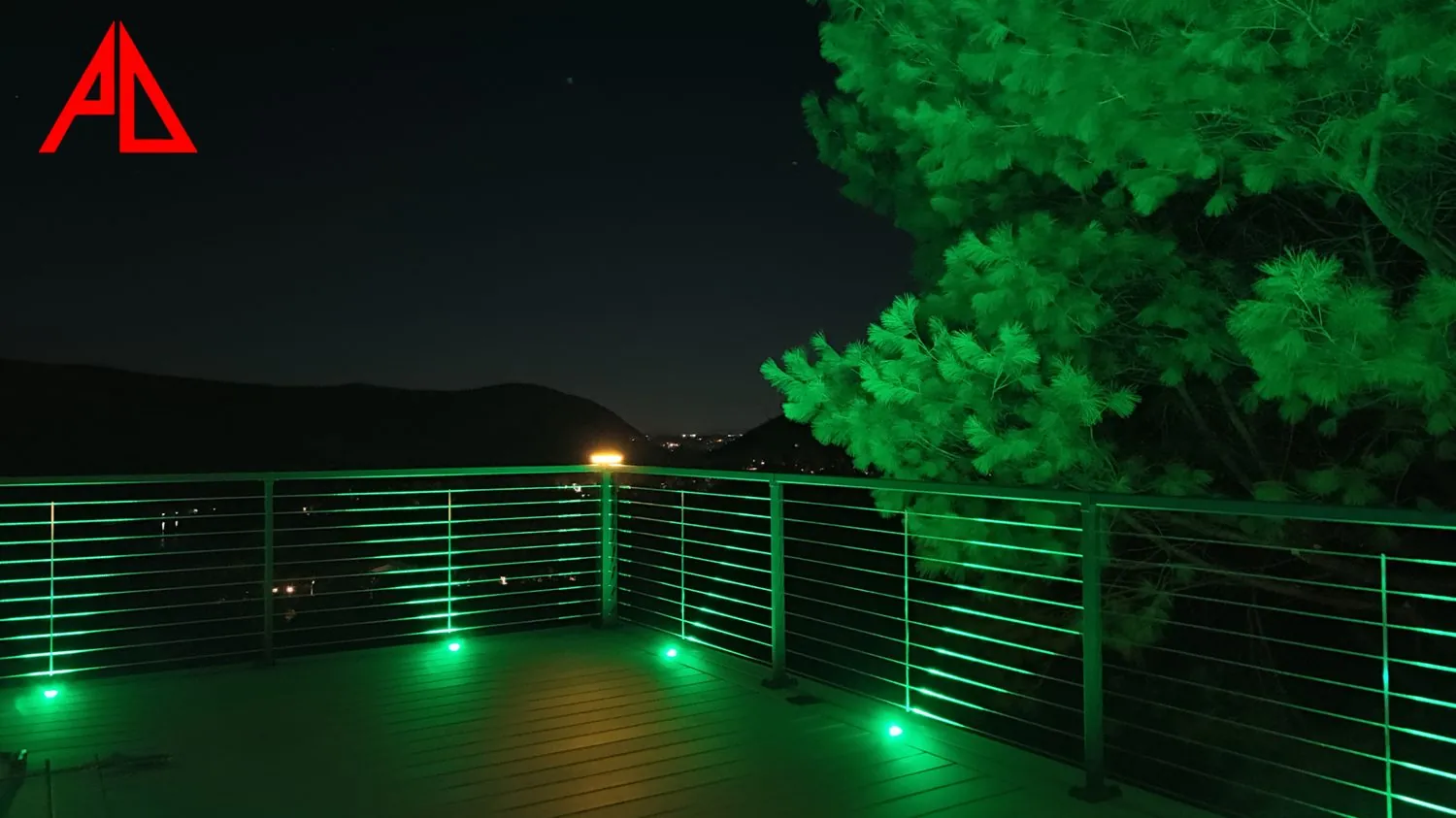 Trex deck with aluminum cable railing and LED lighting at night — Pinnacle Decking Hudson Valley NY