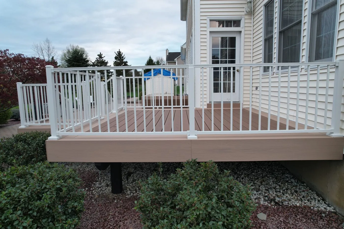 Elevated Trex Signature deck with white aluminum railing, drone view — Pinnacle Decking Hudson Valley NY