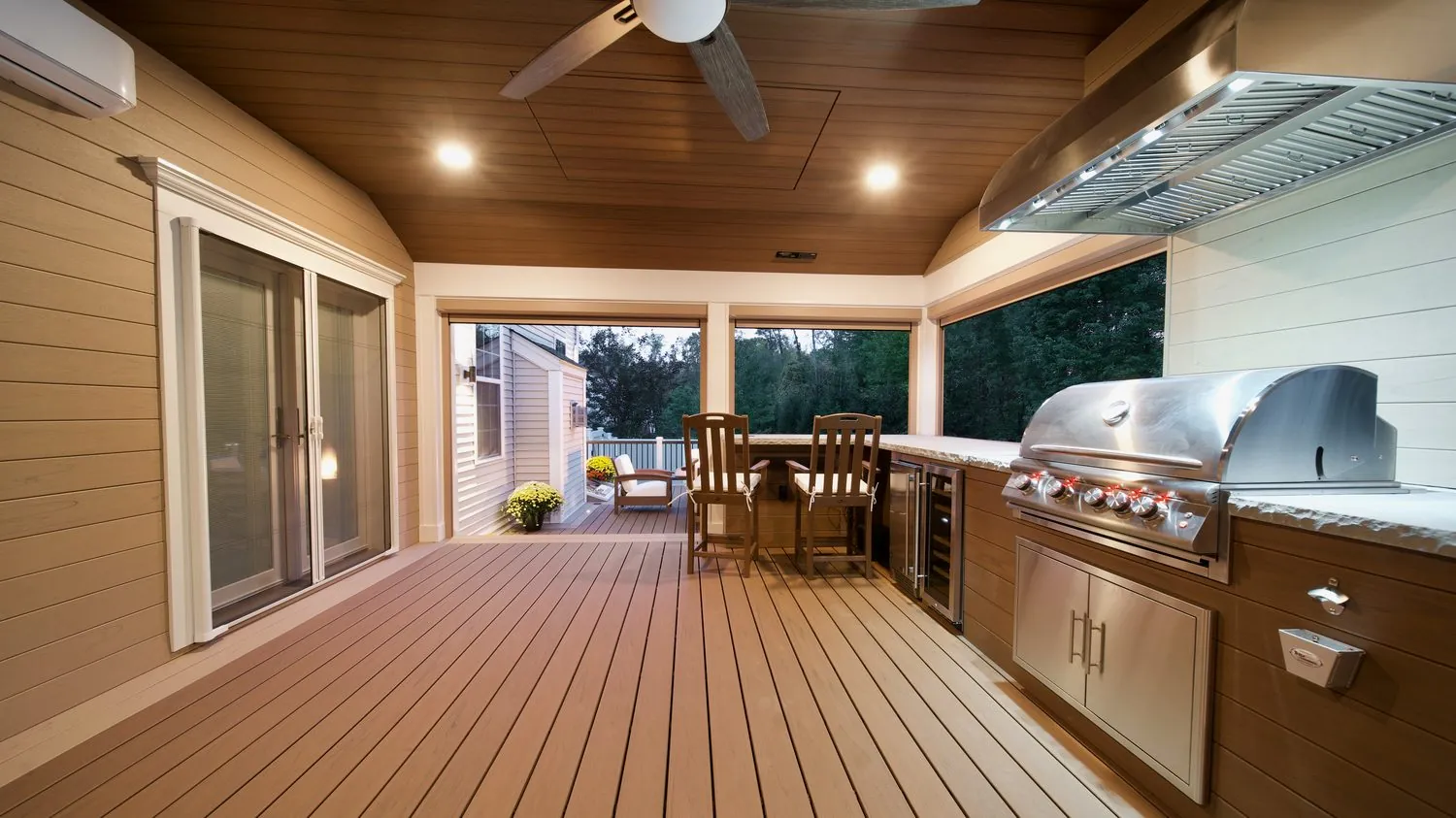 Covered outdoor kitchen with cedar ceiling and stainless grill at dusk — Pinnacle Decking Hudson Valley NY